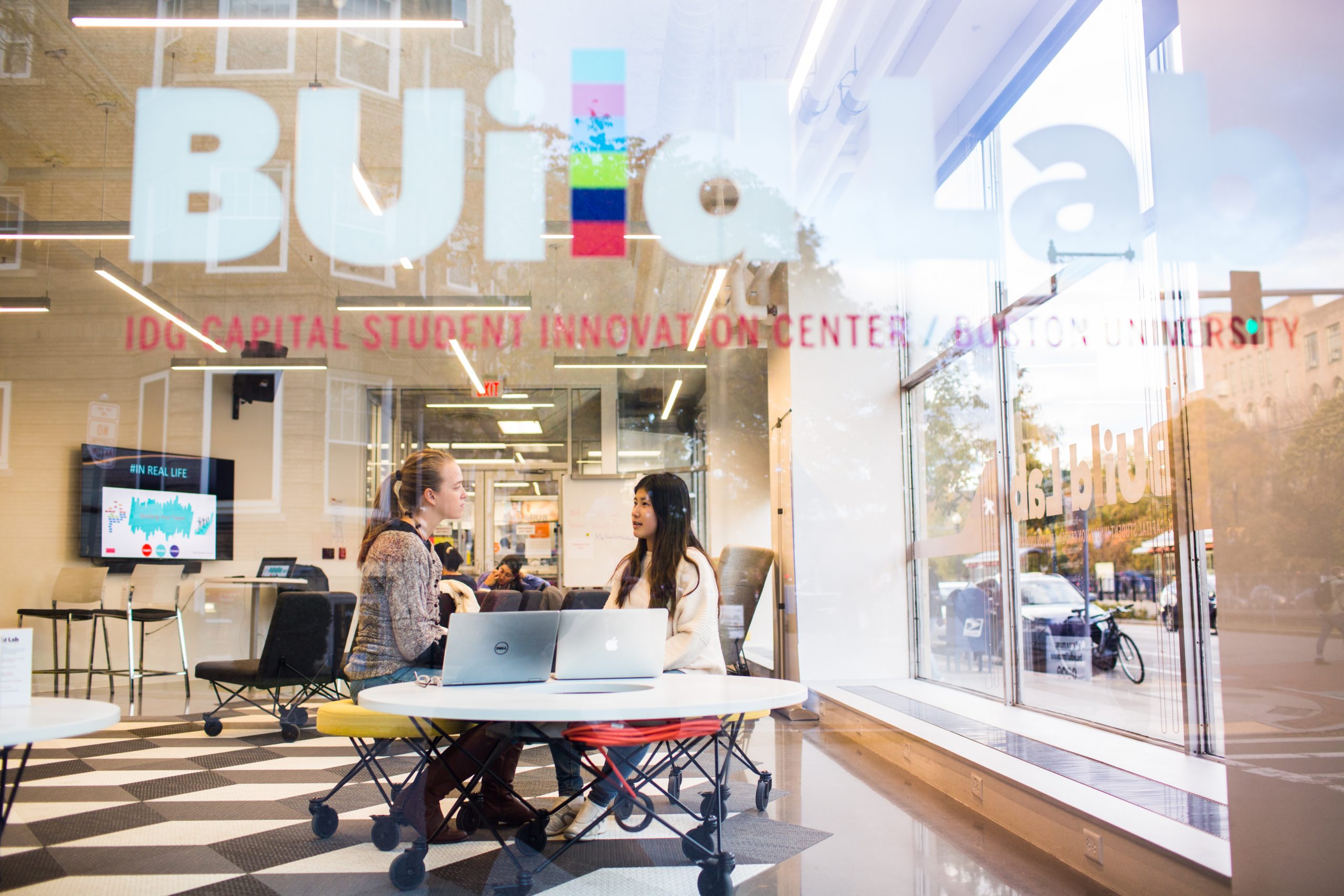 Hub students at BUild Lab, sitting at a table.