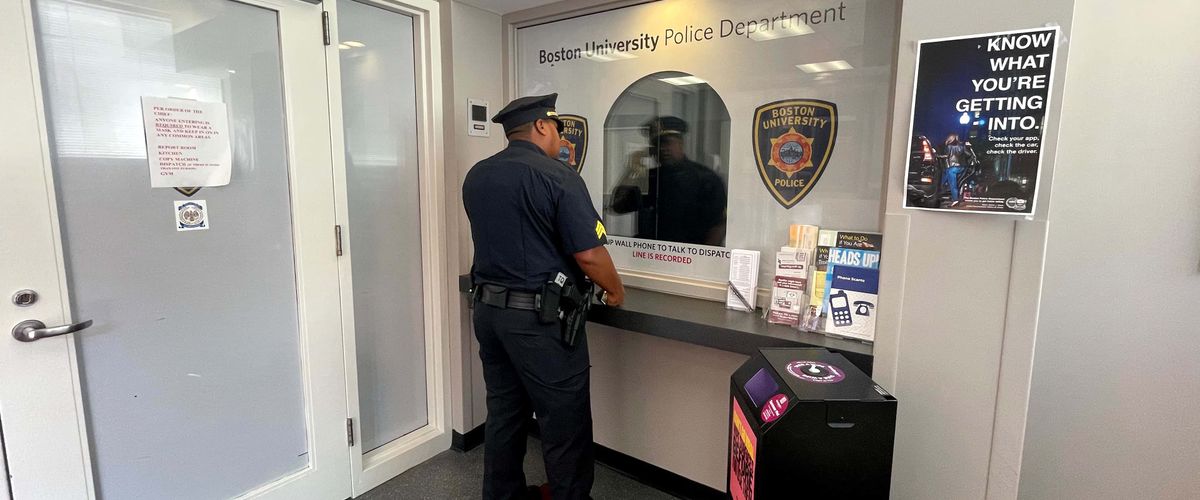 BUPD officer standing in front of dispatch desk