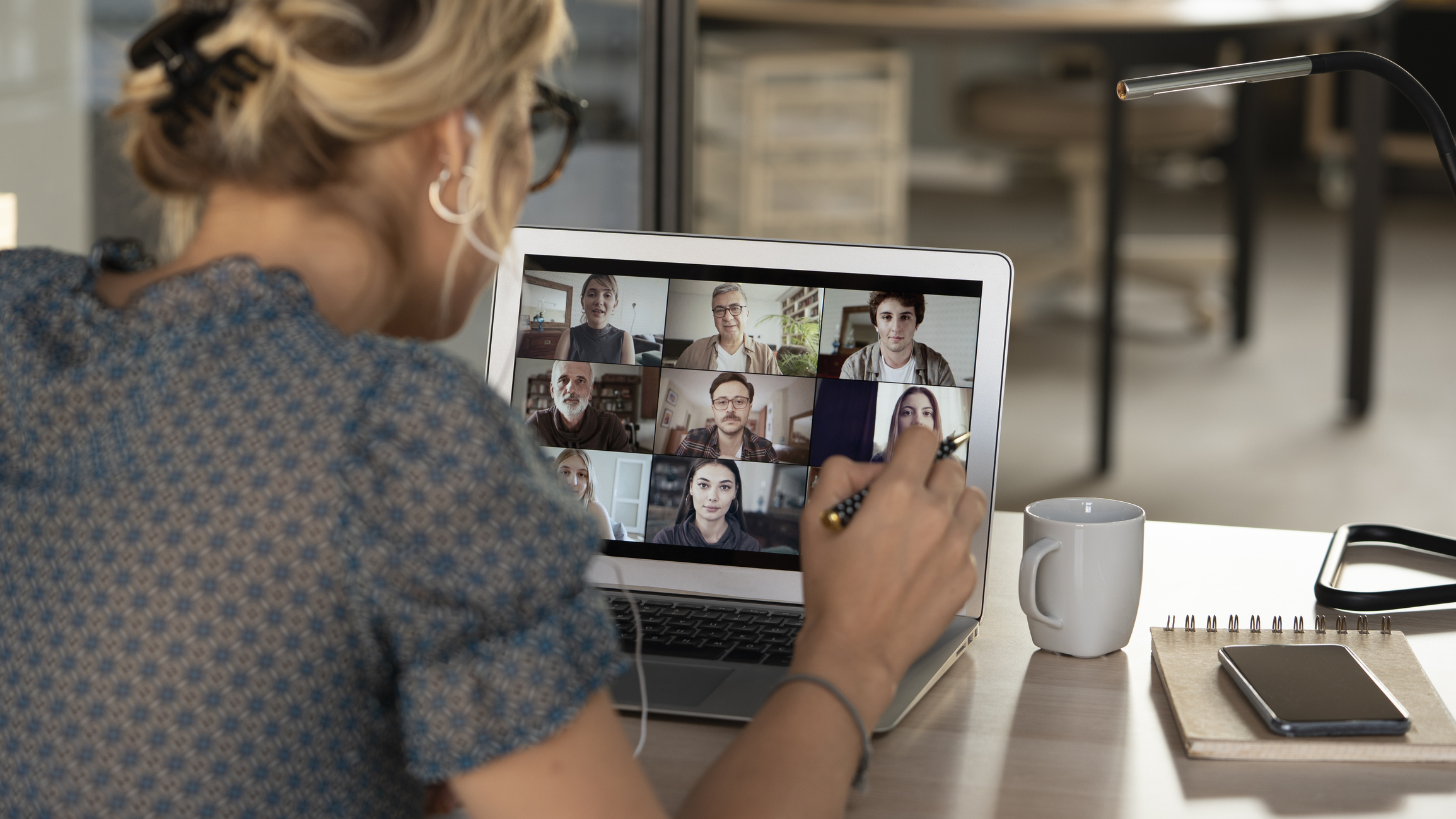 Woman talking to people through her laptop on a video conference call