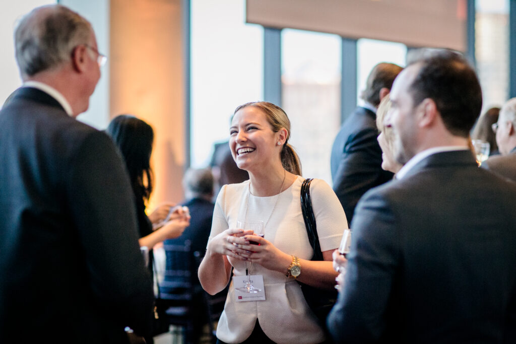 Women smiling talking with two men.
