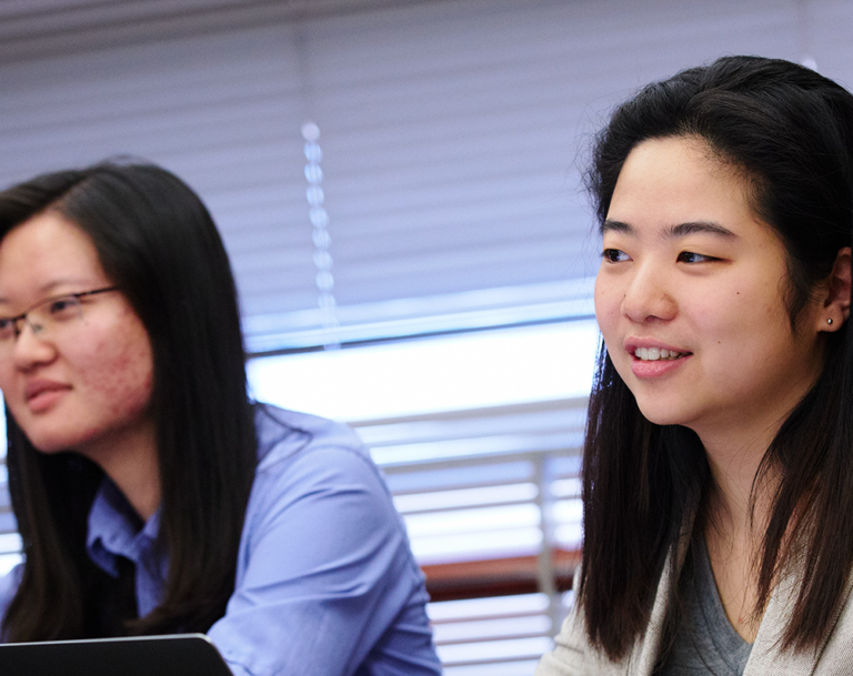 Female student sitting in classroom.