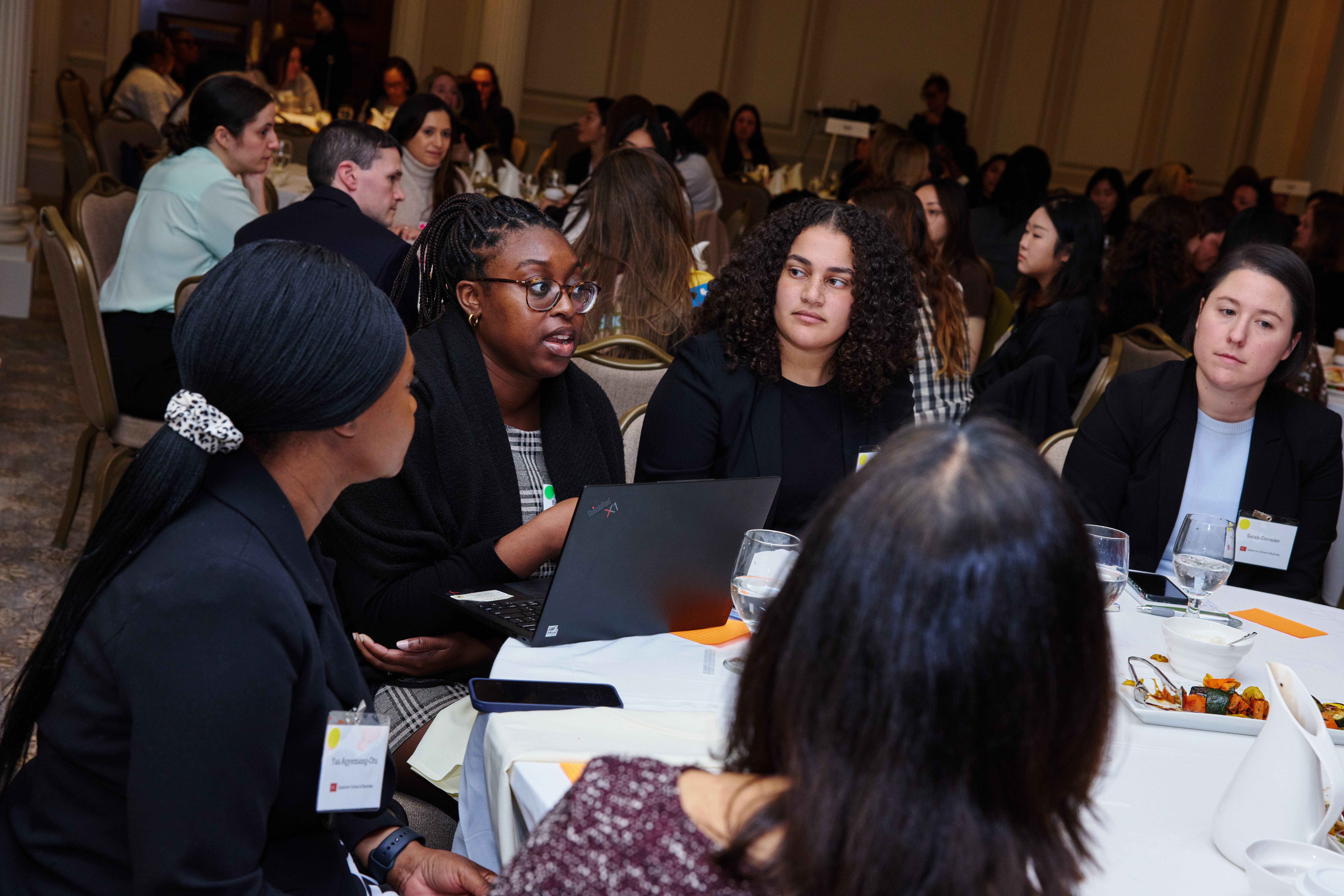 Several women students speak at a round table