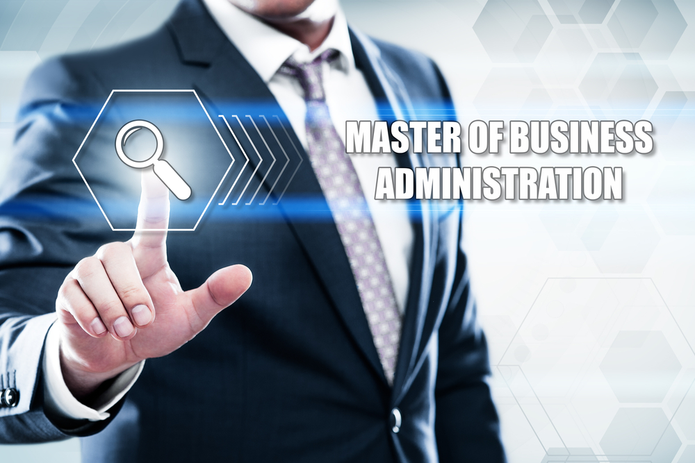 A man in a suit touches a graphic on the screen that reads Master of Business Adminiatration.