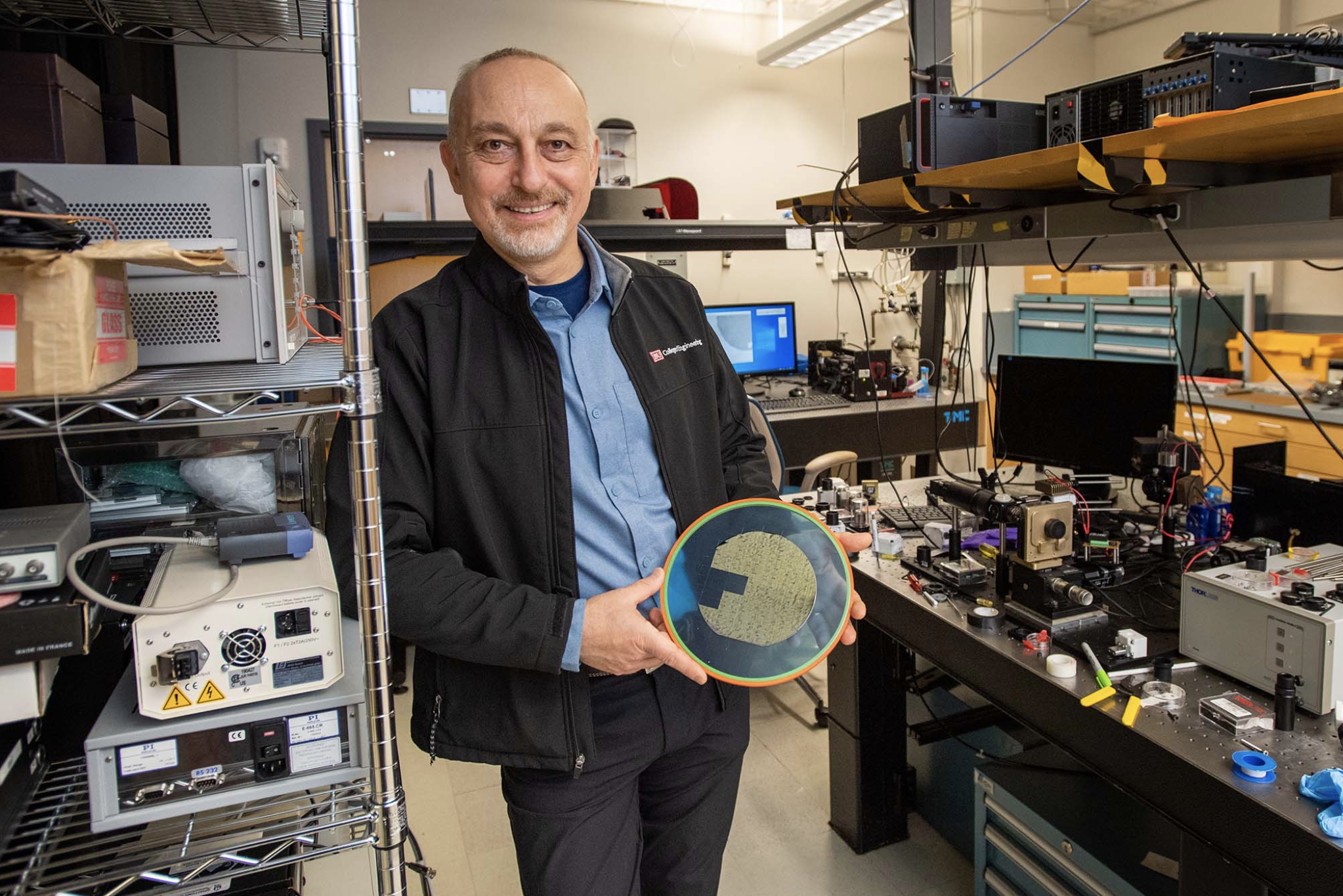 BU faculty member holding a new technology