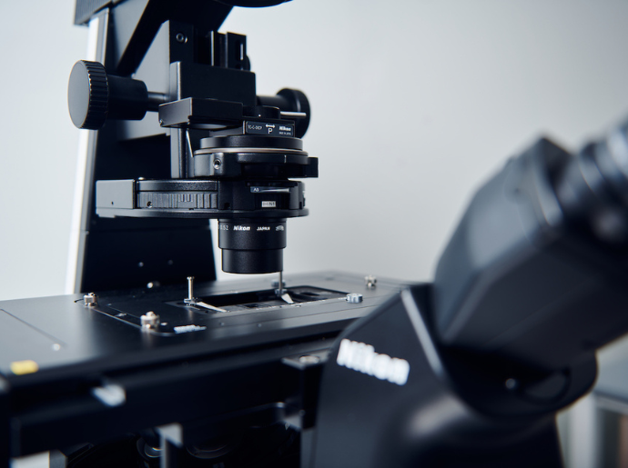 A close up photo of a black laboratory microscope