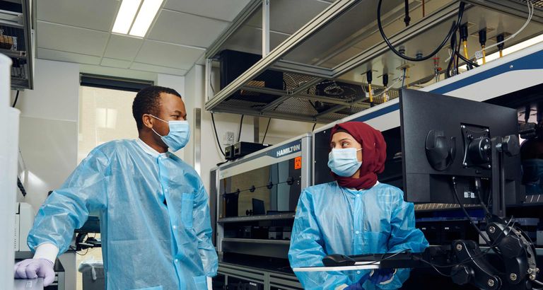 Two researchers interacting in lab