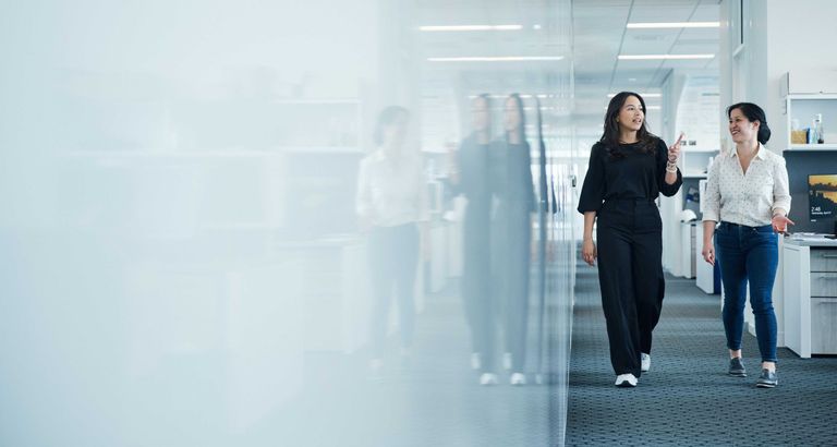 two-women-walking-in-hallway