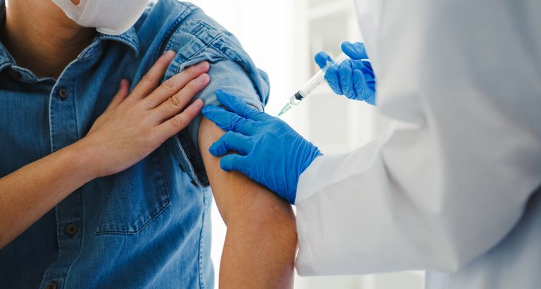 Doctor giving vaccine to patient