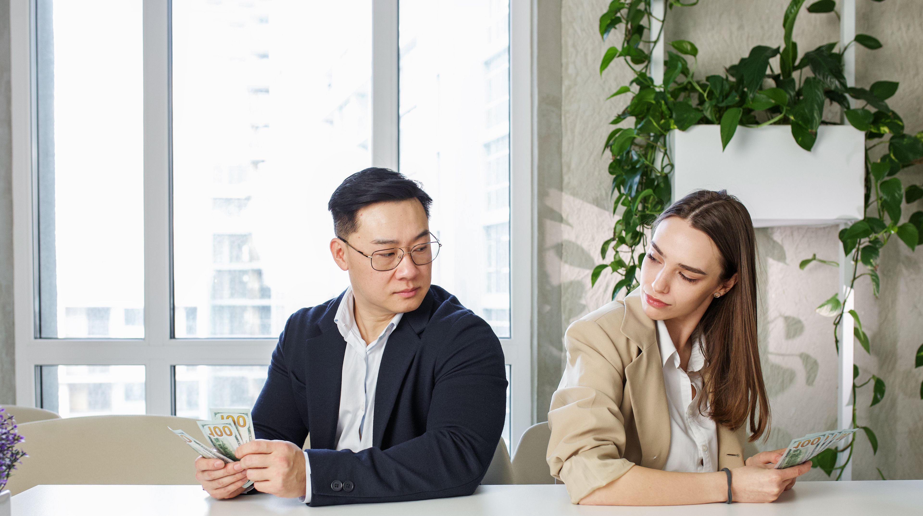 Money, gender bias and salary inequality in workplace between team of equal professional employee colleagues.