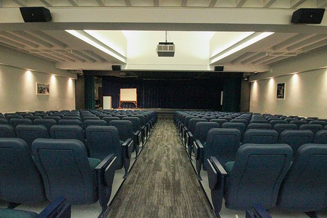 View of GSU Auditorium from the back of the center aisles, with all empty rows of seats.