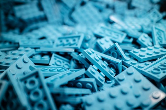 Blue tinted image of a bunch of Lego pieces.