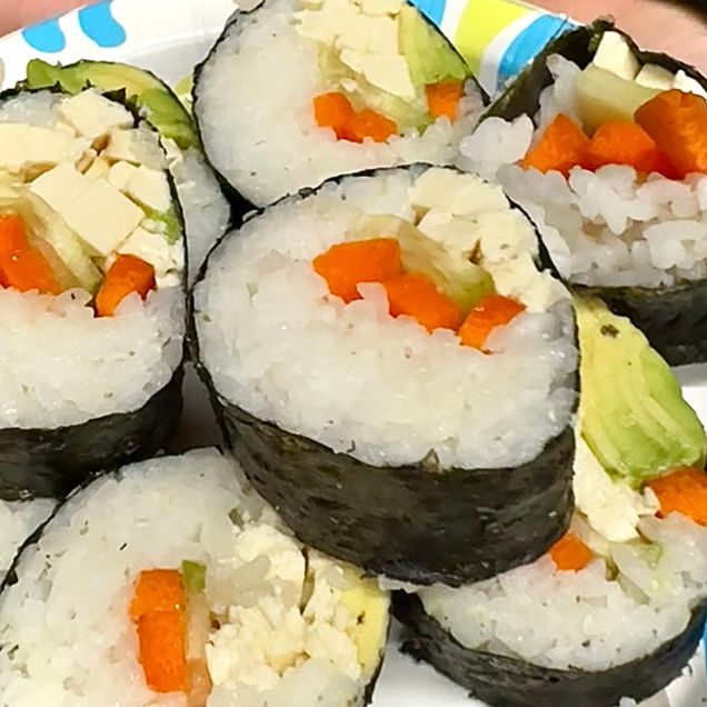The sushi roll was cut, into bite size pieces. In the piece you see that the sushi is stuffed with tofu, avocado, carrot, and cucumber pieces, that are surrounded by sushi rice wrapped in nori seaweed paper.