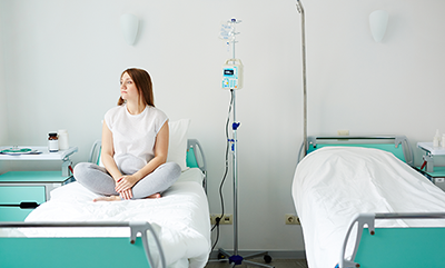 woman sitting on hospital bed