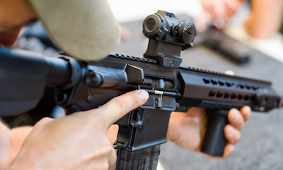 Close up of man aiming rifle