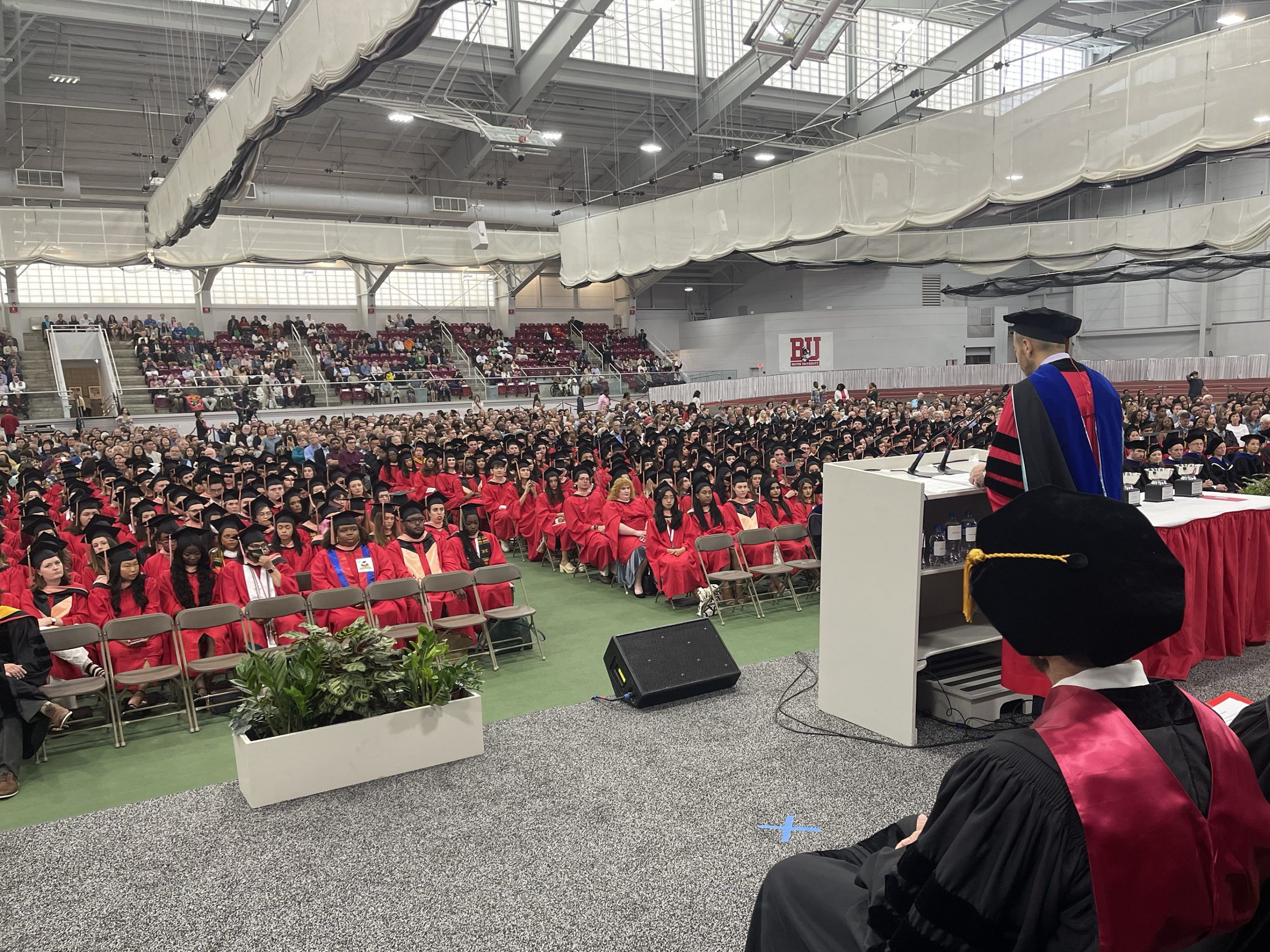 Dean Galea speaks at lectern to BUSPH graduates