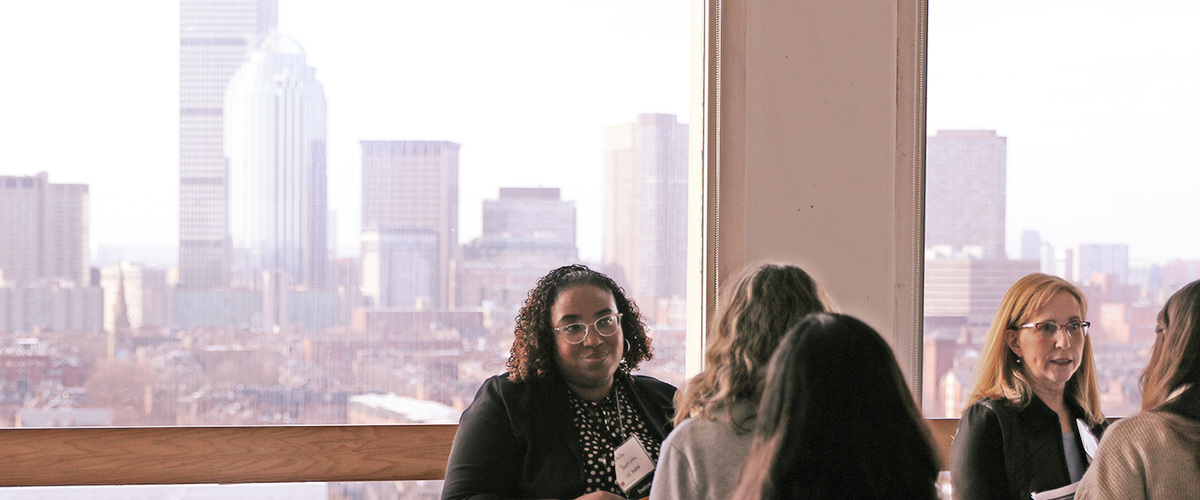 Employers and students at the 2023 Career Fair, with the Boston skyline in the background