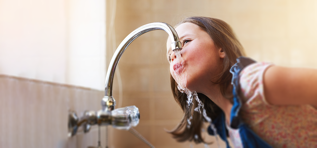 Girl drinking from tap