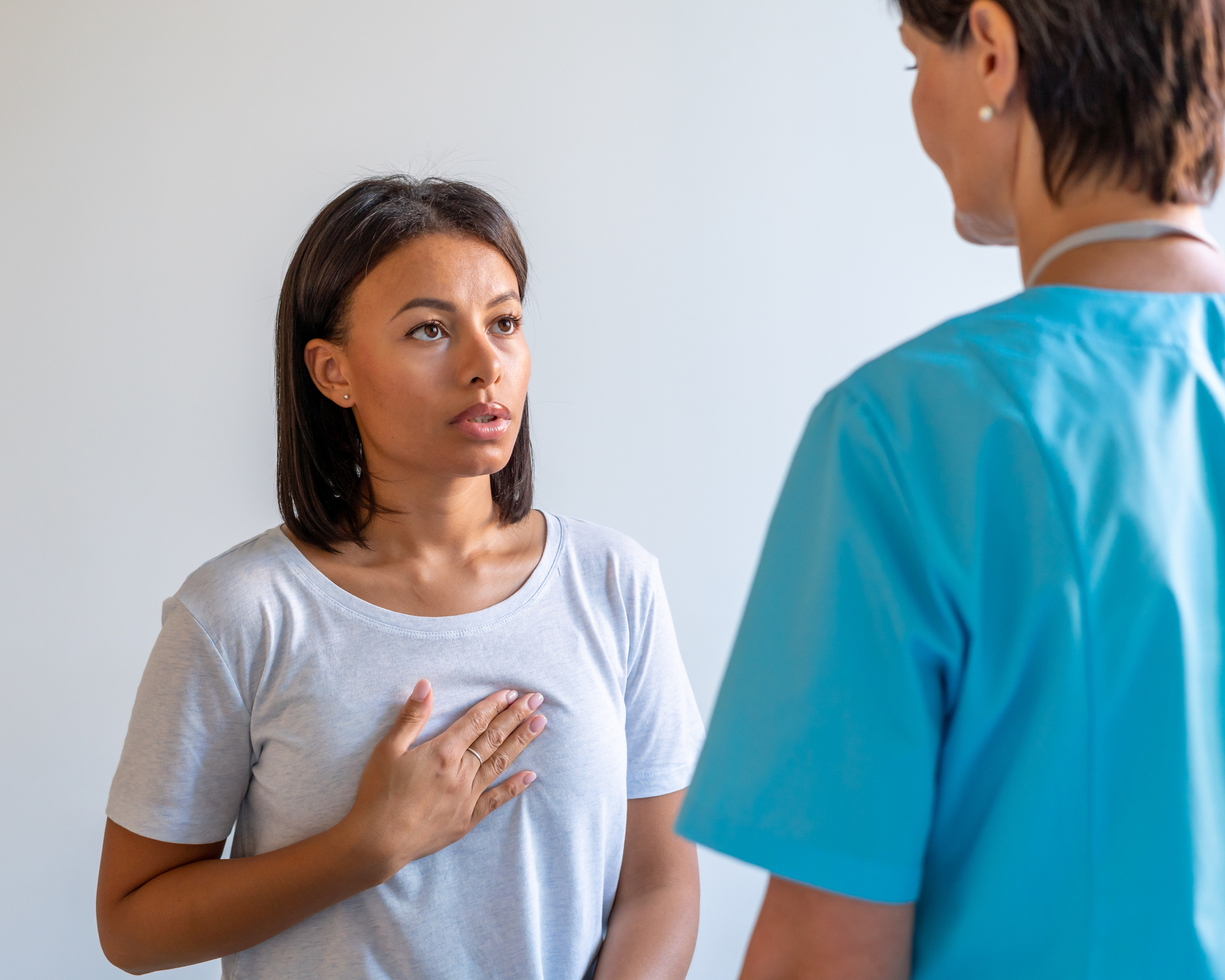 African american patient complaining about heartache in chest