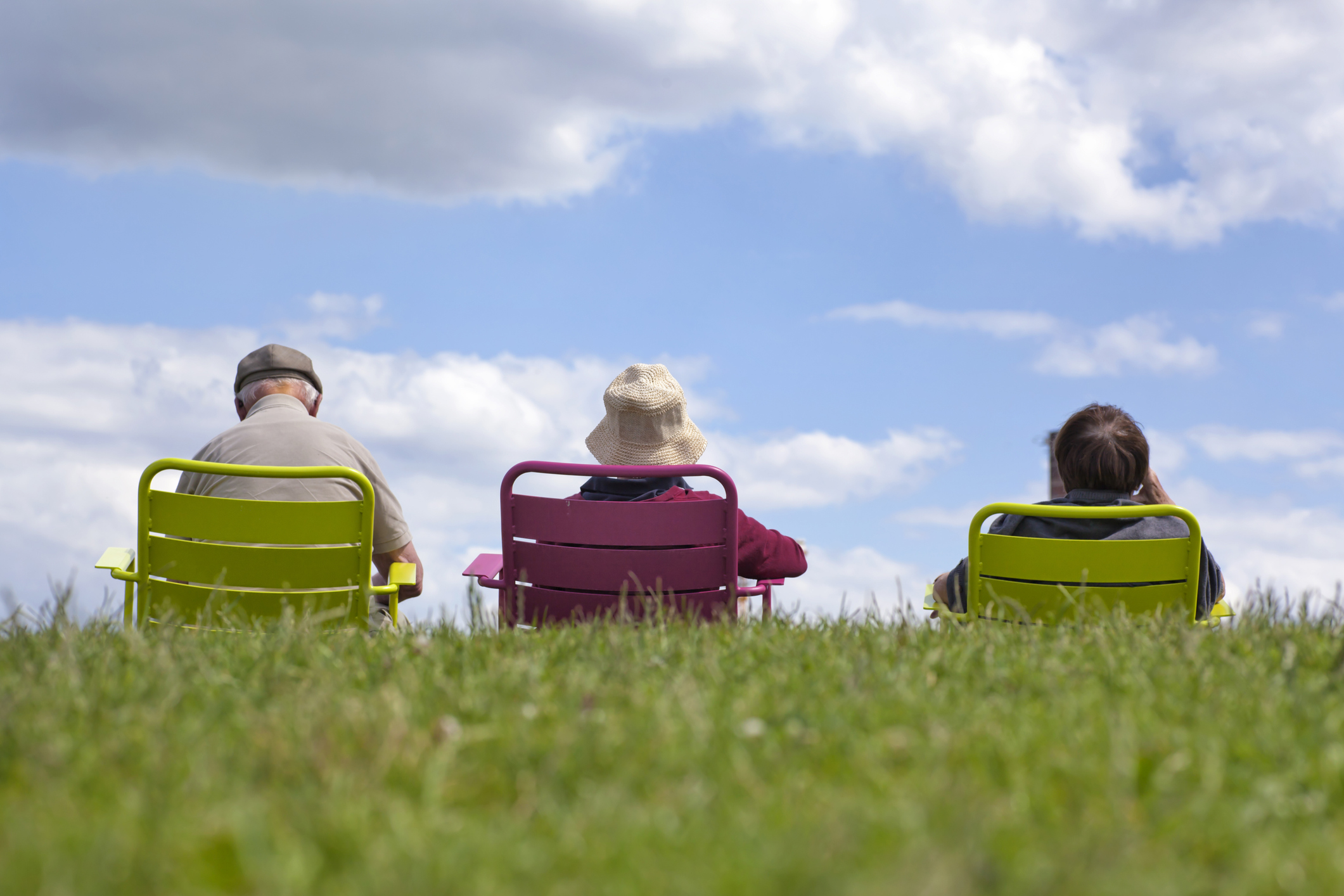 Family enjoying recreation - relaxing in the park against a clear blue sky.