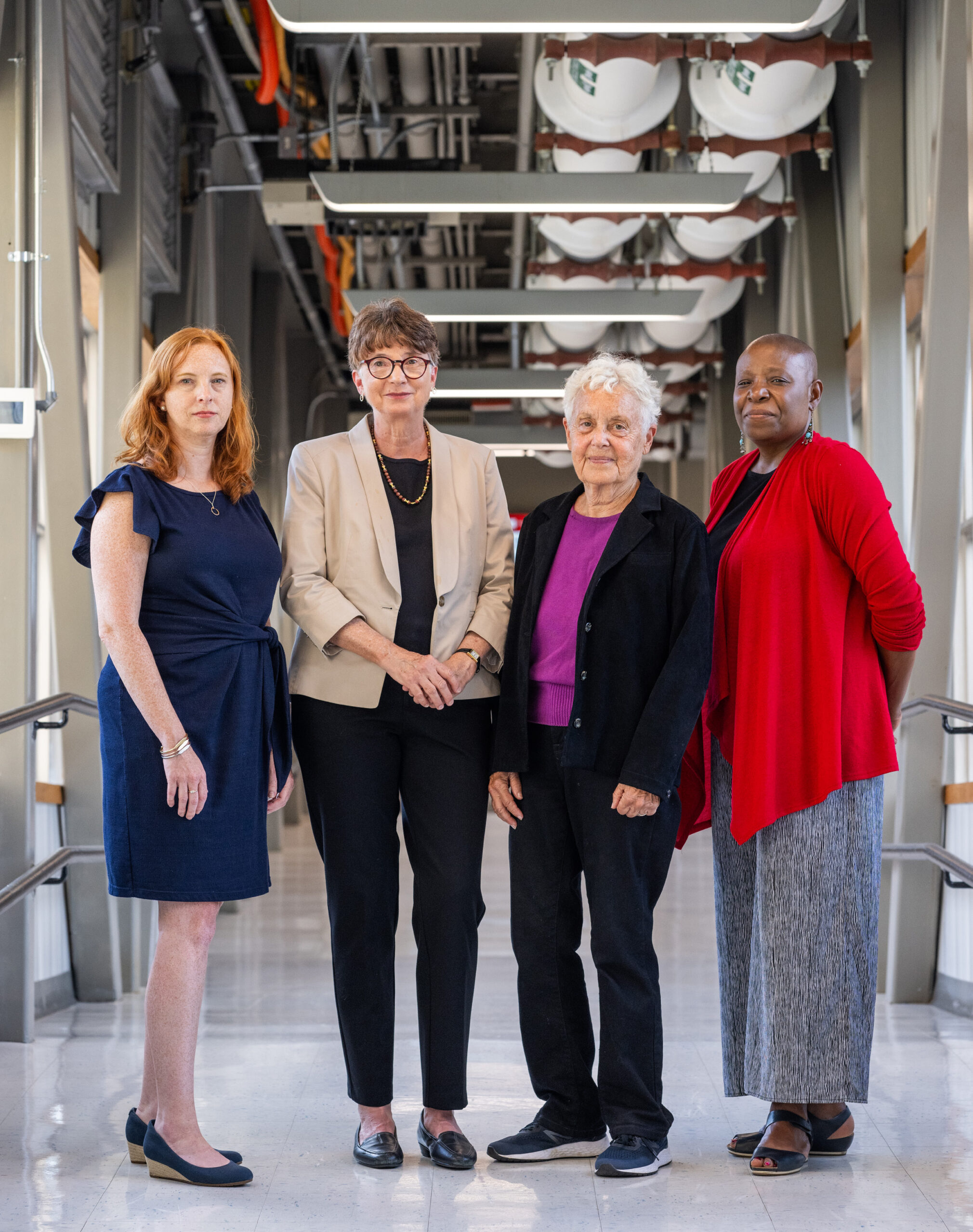 Kimberly Bertrand, Julie Palmer, Lynn Rosenberg, and Yvette Cozier stand in a hallway