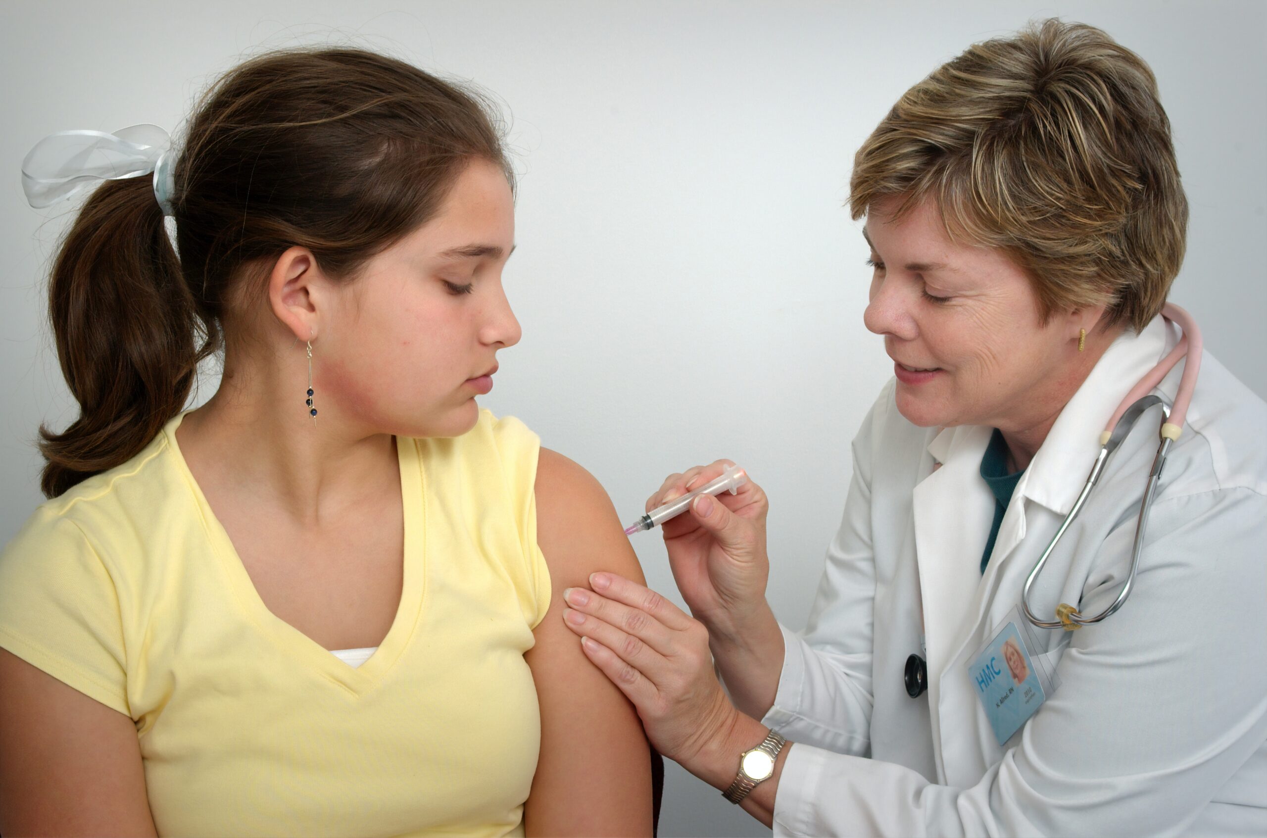 A nurse administers a vaccination to a child