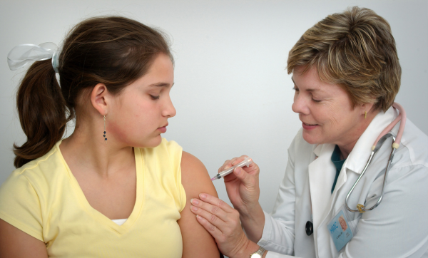 A nurse administers a vaccination to a child