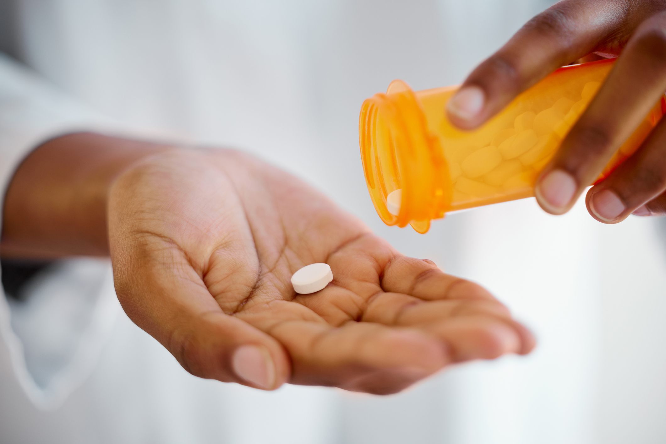 Shot of a person's hands taking tablets