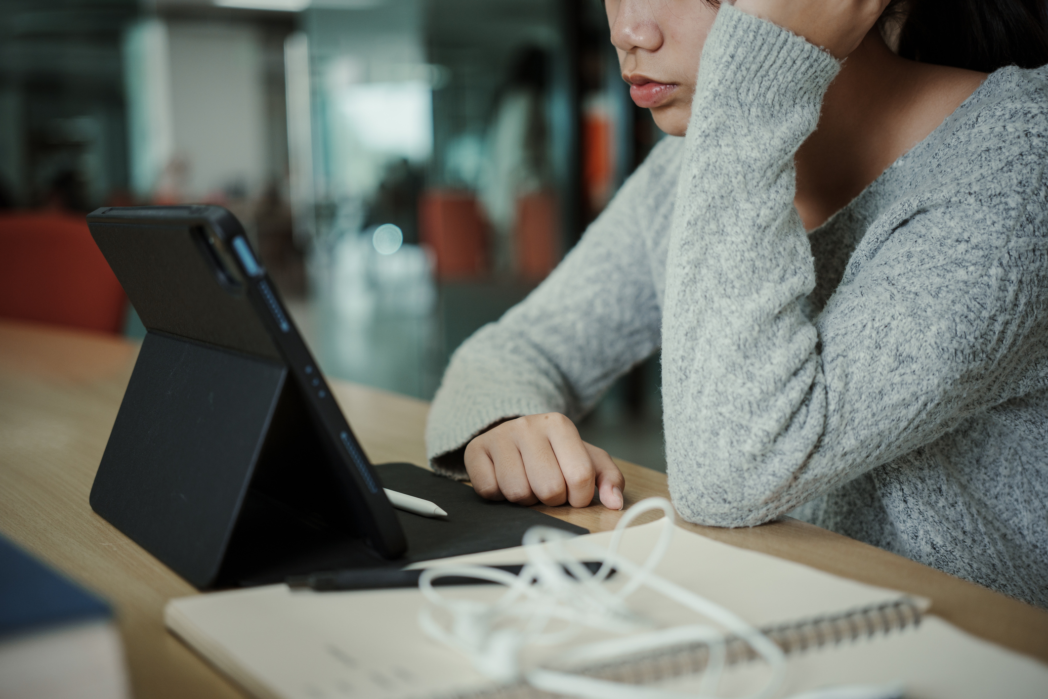 Asian student woman read books in library at university. Young girl stress tired have problem while study hard. Sadness concept