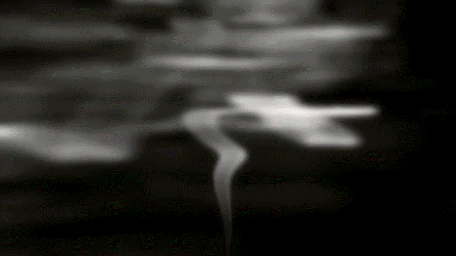 GIF in black and white of smoke rising from lower center of the screen