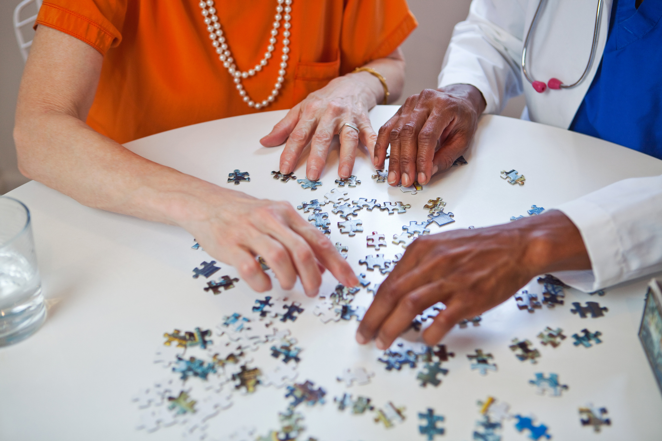 Senior woman and doctor with jigsaw puzzle
