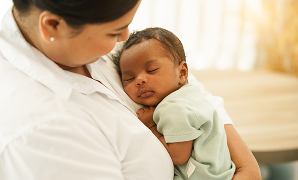 Latina mother holding young infant