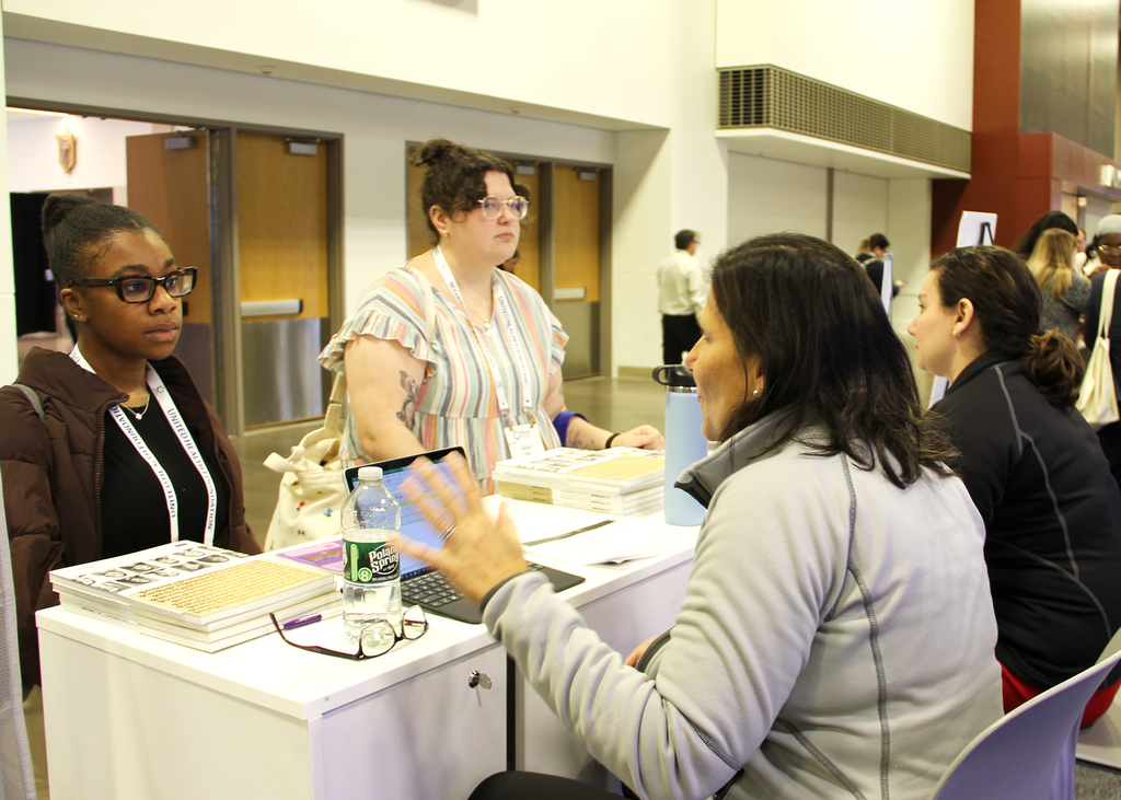 Admissions talking with folks at the APHA booth
