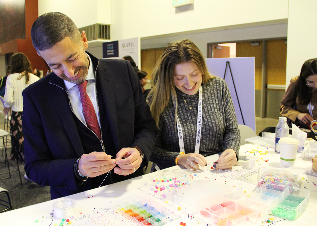 Dean Galea and Isabelle Kiritsy making friendship bracelets