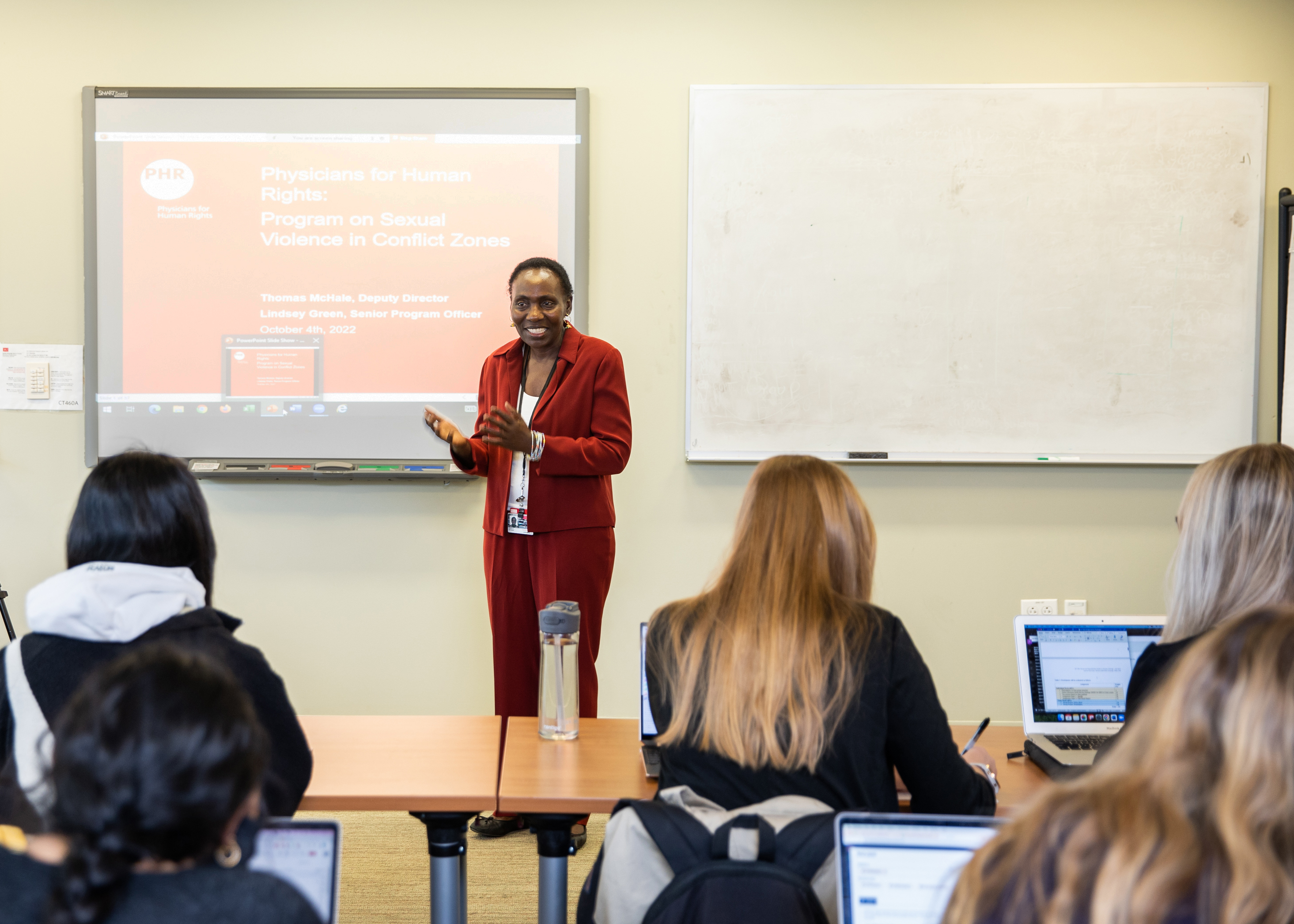 Monica Onyango, clinical associate professor of global health, delivers a lecture to a classroom of students.