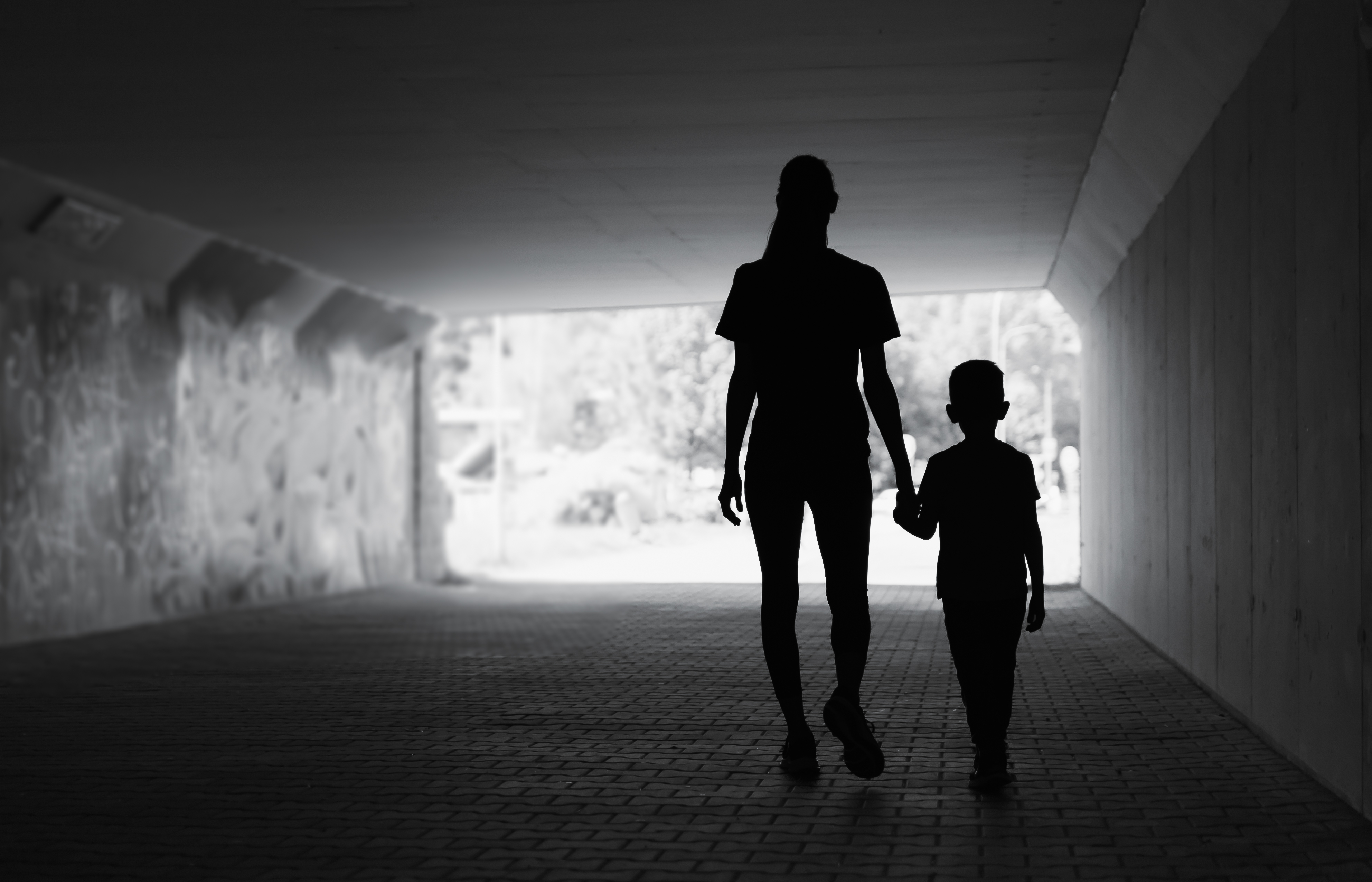 Mother and son walking in the city.