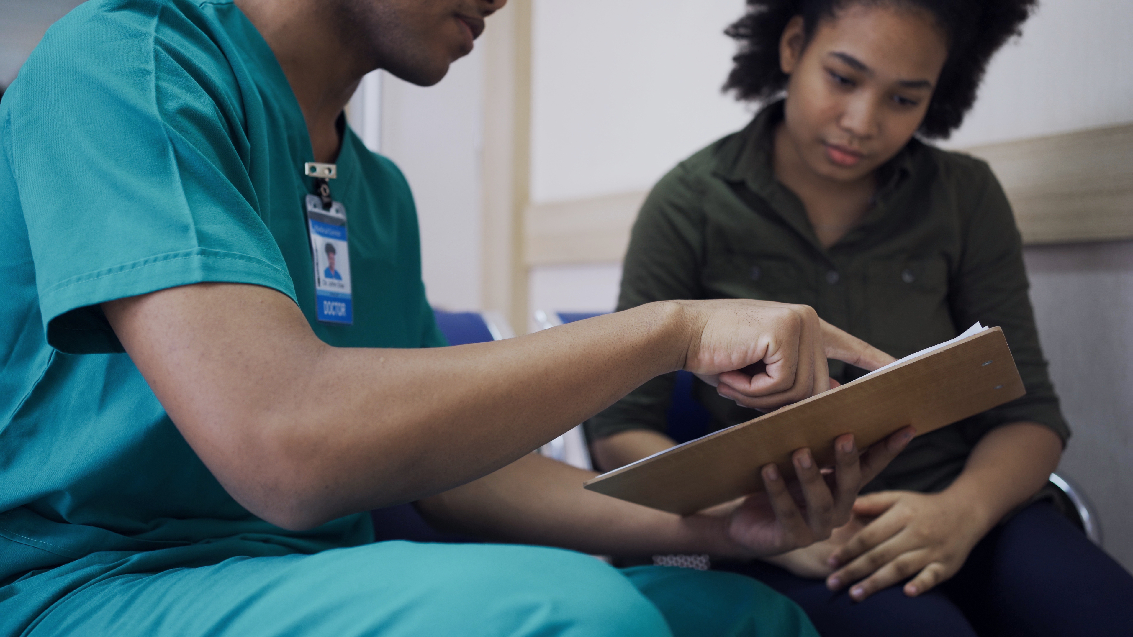 Doctor talk with a patient at hospital. Health and wellness.