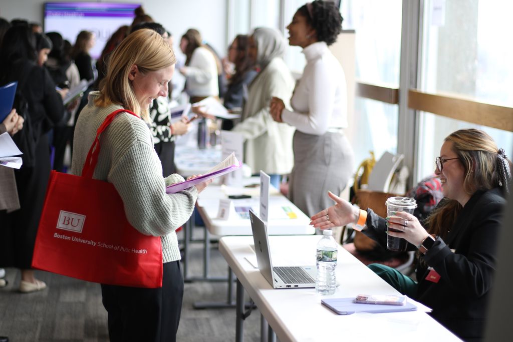 A student speaks with a staff member of a visiting organization during the spring 2025 career fair.