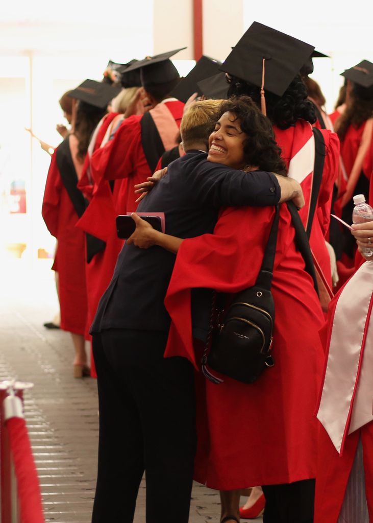 瑞安Wisniewski, staff advisor to SPH's Queer Alliance, and 艾莎Ghorashian, former QA administrative officer, share a celebratory hug at convocation.