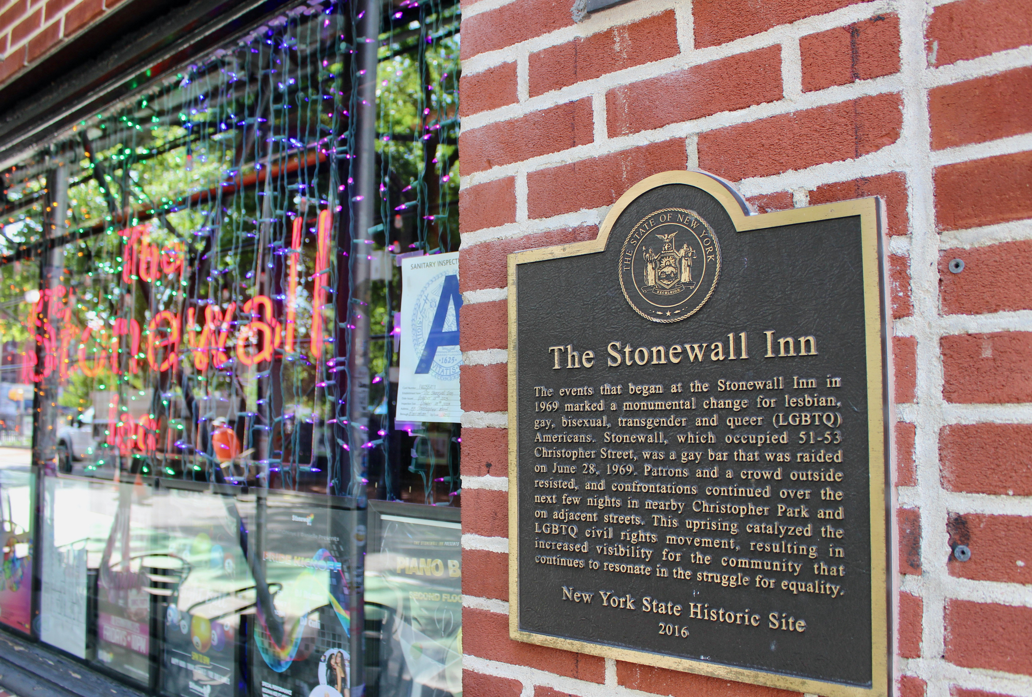 Sign and plaque on the facade of The Stonewall Inn on Christopher Street in Greenwich Village, NYC
