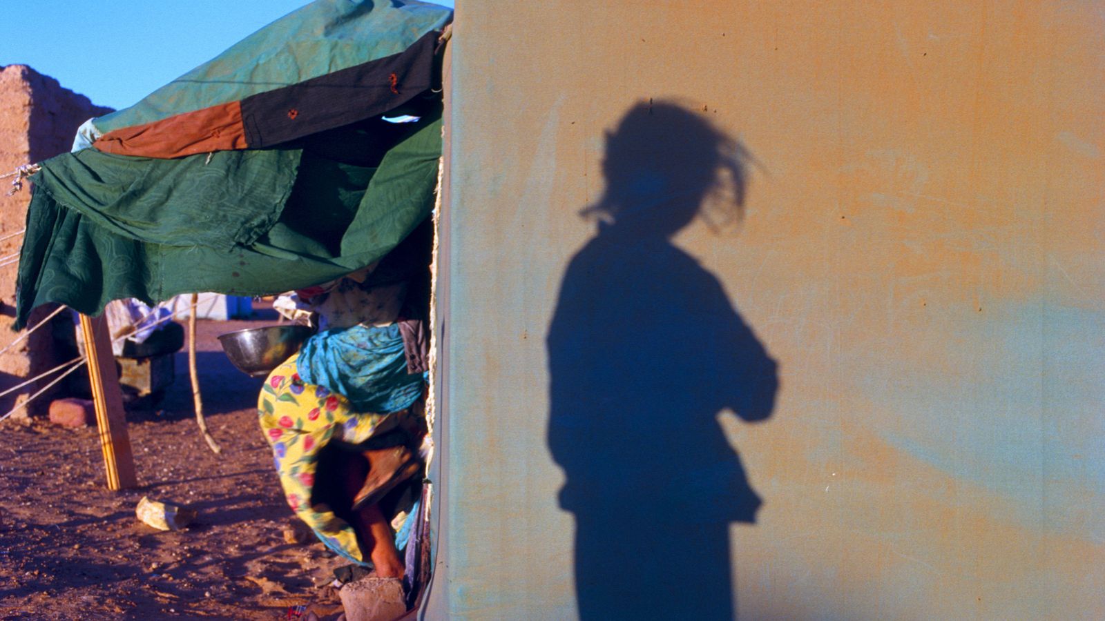shadow of a girl in a refugee camp