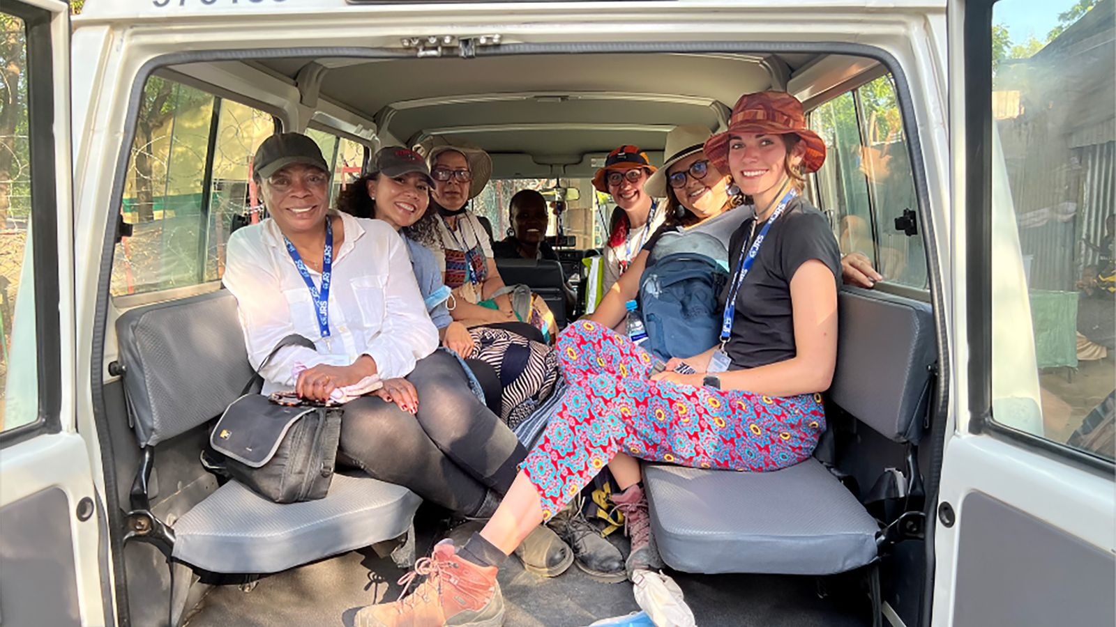 The SSW group in their transport vehicle. Clockwise from front left: Margaret Lombe; Tee Thach; Monica Salazar; a JRS staff member; Stacy Karabetsos; Ellie Zambrano, executive director of the BU Center for Innovation in Social Work & Health; and Megan Hart (SSW’23). Photo courtesy of Lombe
