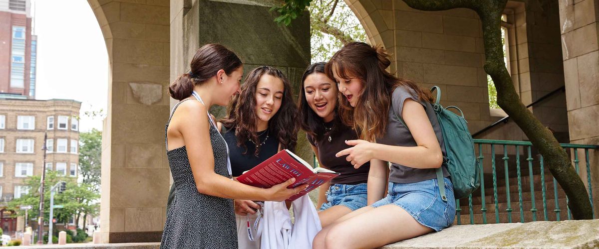 Four Boston University Students review a book on campus