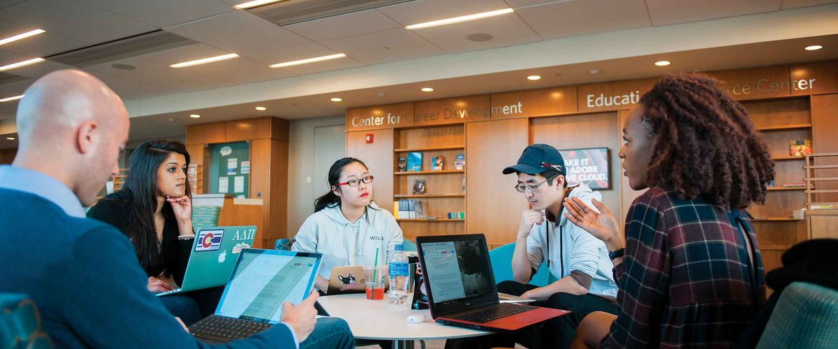 BU Summer Term students in a library on campus