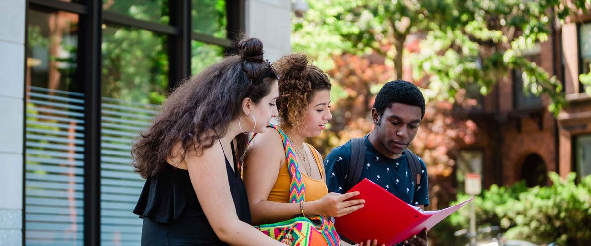 BU Summer Term students go over a folder.
