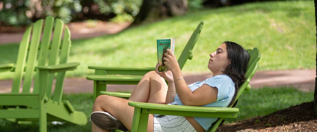 A BU Summer Term student reading at BU Beach