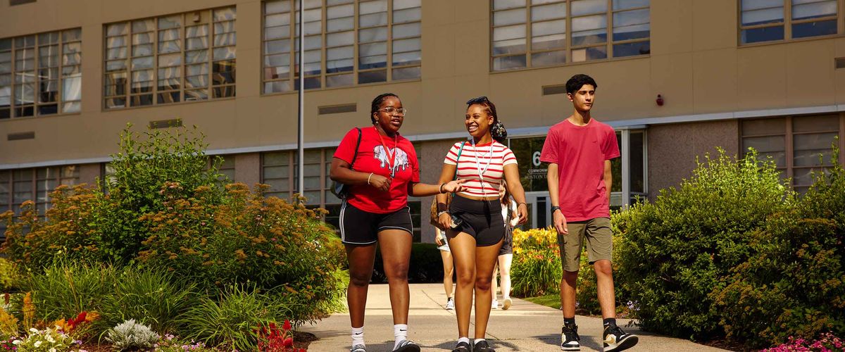 Three high school students walking through Boston University's campus during Summer Term