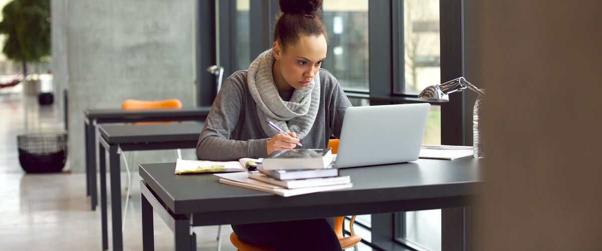 Person using a laptop in a study space