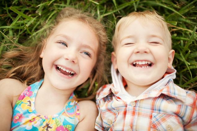 Sister and brother kids laughing. Top view.