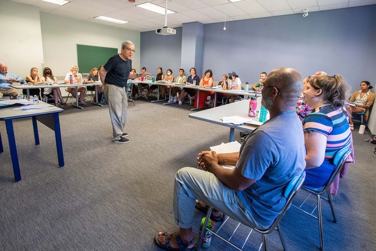 A group of teachers listening to a lecture.