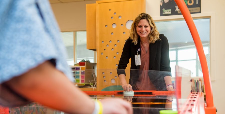 child life graduate playing with patient at tufts medical center